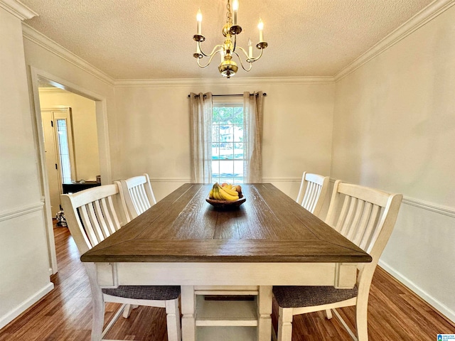 unfurnished dining area featuring a chandelier, crown molding, a textured ceiling, and dark hardwood / wood-style flooring