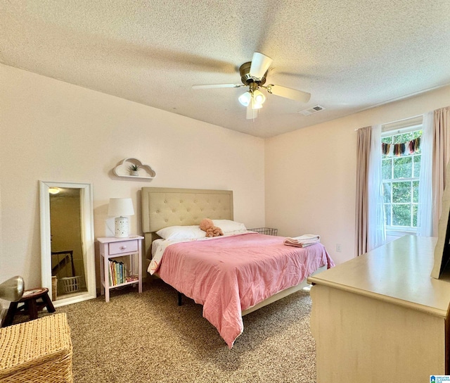 carpeted bedroom featuring a textured ceiling and ceiling fan