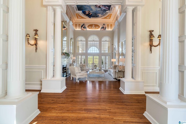 entryway with ornamental molding and dark hardwood / wood-style flooring