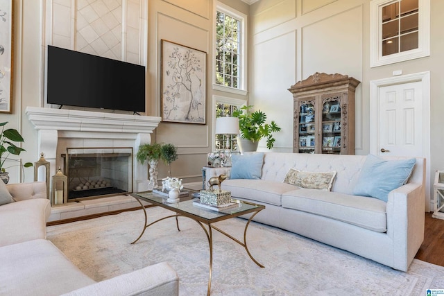 living room featuring hardwood / wood-style flooring and a towering ceiling