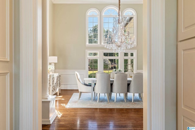 dining room featuring ornamental molding, an inviting chandelier, and hardwood / wood-style floors