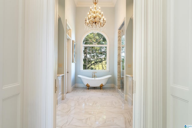 bathroom featuring a notable chandelier, a tub to relax in, and crown molding