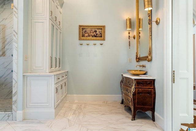 bathroom featuring vanity and tiled shower