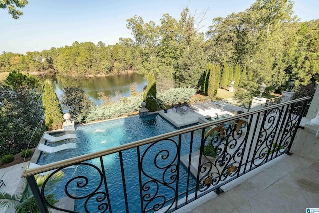 view of pool featuring a patio and a water view