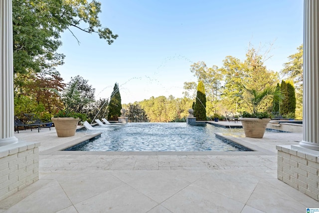 view of swimming pool featuring a patio area and pool water feature