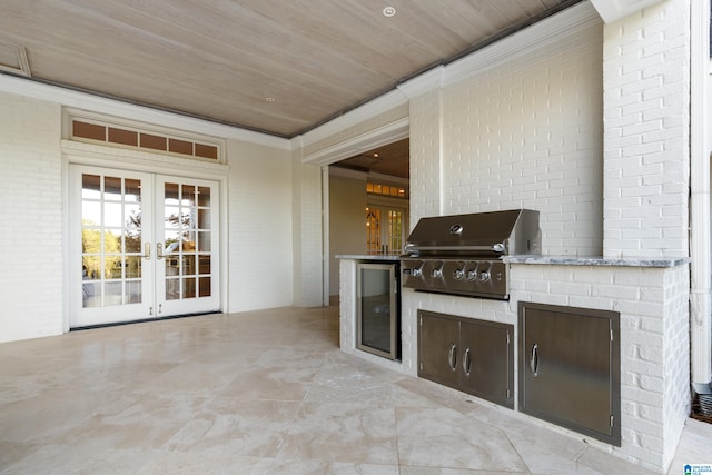 view of patio / terrace featuring french doors, area for grilling, and exterior kitchen