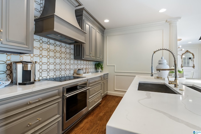 kitchen with gray cabinets, custom exhaust hood, dark hardwood / wood-style flooring, and oven