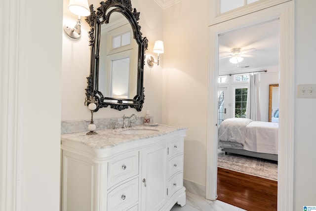 bathroom featuring vanity, ceiling fan, wood-type flooring, and ornamental molding