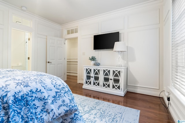 bedroom featuring crown molding and dark hardwood / wood-style floors