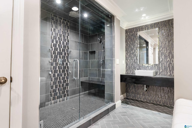 bathroom with ornamental molding, sink, and walk in shower