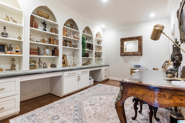 office featuring built in desk, ornamental molding, and dark hardwood / wood-style flooring