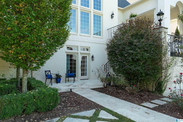 view of exterior entry with a patio