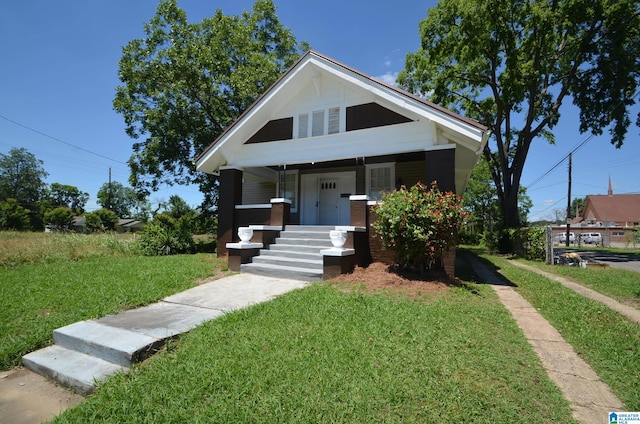 bungalow-style home with a front yard and a porch