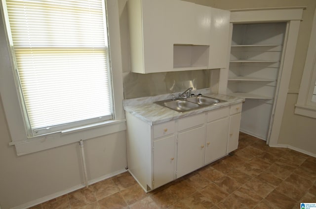 kitchen with white cabinetry and sink