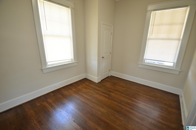 spare room with dark hardwood / wood-style flooring