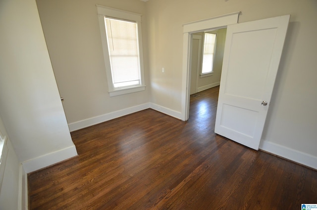 unfurnished room with dark hardwood / wood-style floors