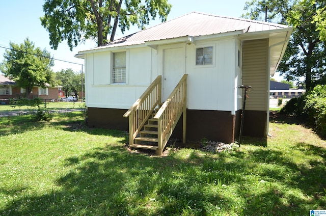 rear view of property with a yard