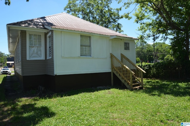 view of side of home featuring a yard