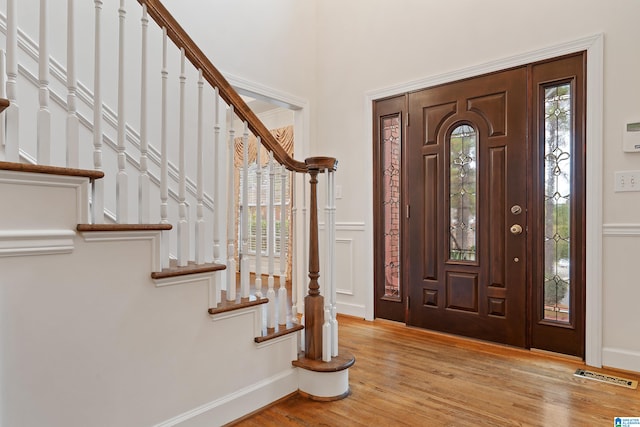 foyer with light wood-type flooring and a wealth of natural light