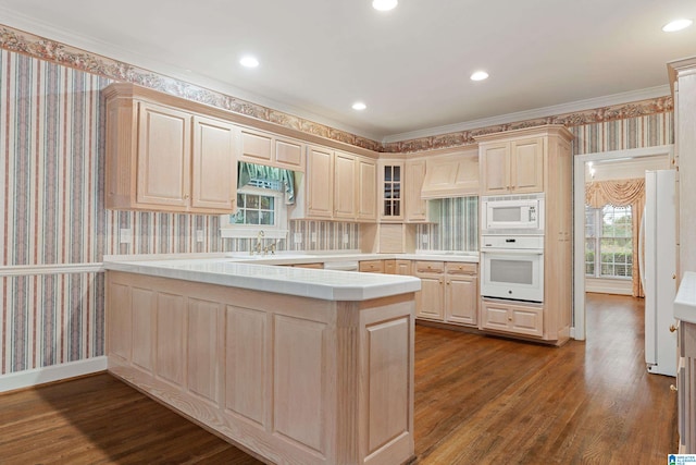 kitchen featuring wood-type flooring, premium range hood, crown molding, white appliances, and kitchen peninsula