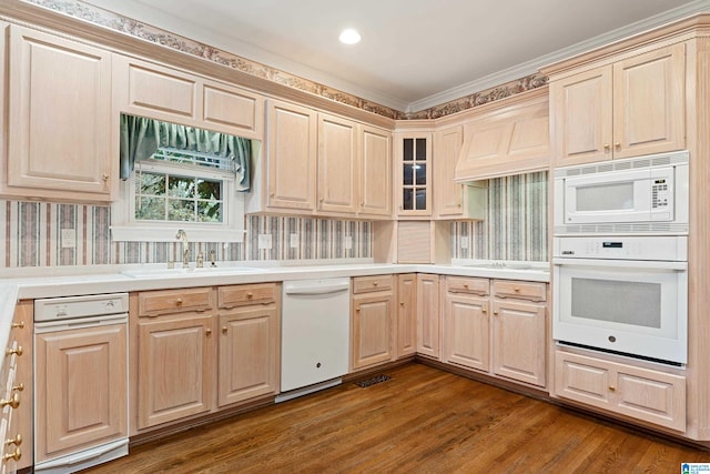 kitchen with tasteful backsplash, ornamental molding, sink, dark wood-type flooring, and white appliances