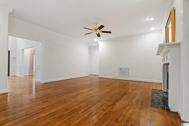 unfurnished living room with ceiling fan, wood-type flooring, and crown molding