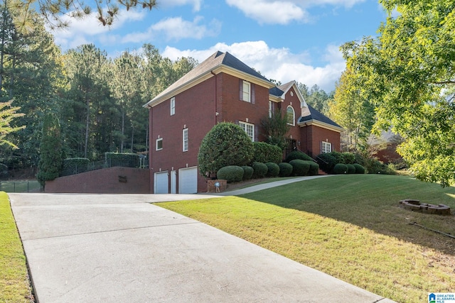 view of home's exterior with a garage and a yard