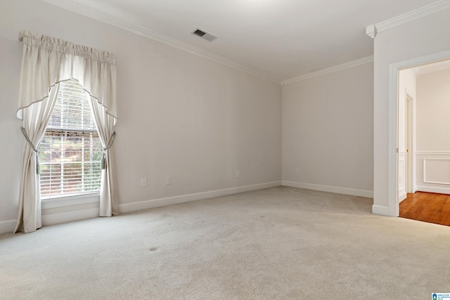 carpeted spare room featuring ornamental molding