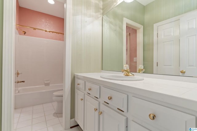 full bathroom with toilet, tiled shower / bath combo, vanity, and tile patterned flooring