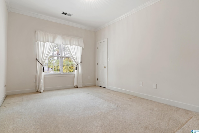 empty room with light carpet and crown molding