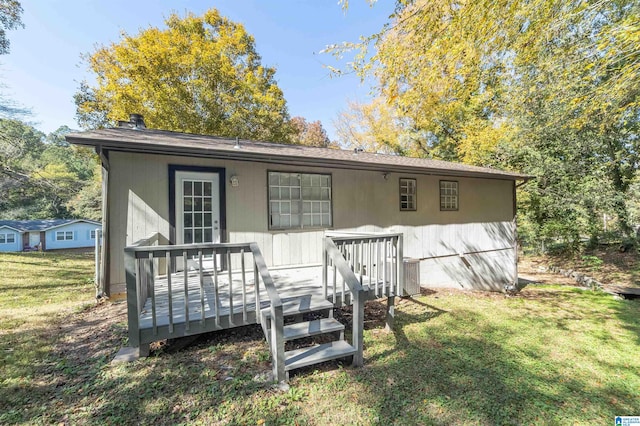 exterior space with central air condition unit, a front yard, and a deck