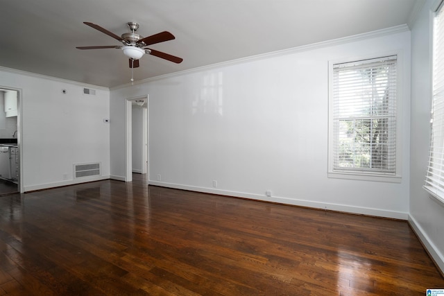 empty room featuring crown molding, dark wood-type flooring, and ceiling fan