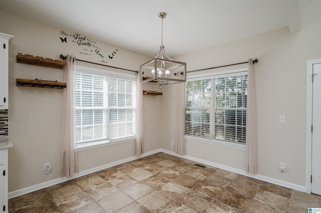 unfurnished dining area with a chandelier