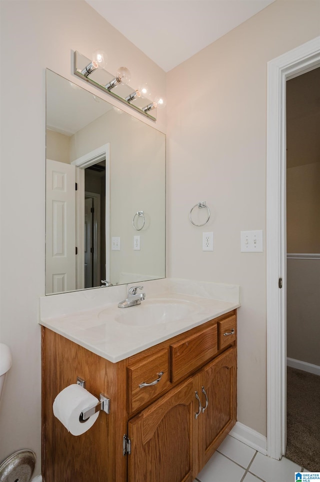 bathroom with vanity, toilet, and tile patterned flooring