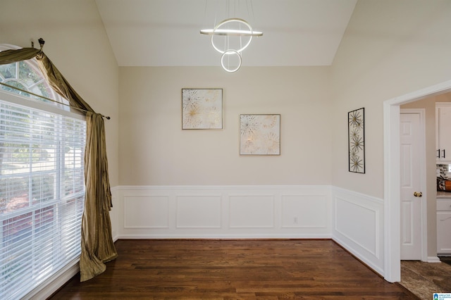 dining area with a notable chandelier, lofted ceiling, and dark hardwood / wood-style floors