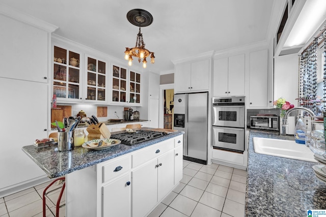 kitchen featuring white cabinets, appliances with stainless steel finishes, light tile patterned flooring, crown molding, and sink