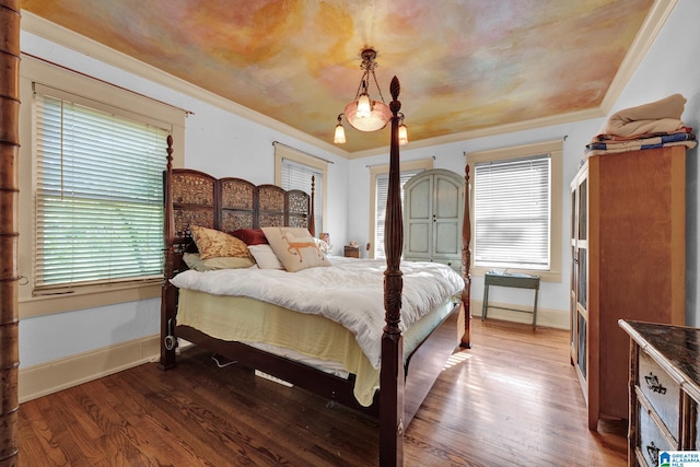 bedroom featuring ornamental molding and wood-type flooring