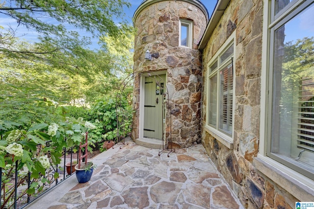 view of exterior entry featuring a patio area