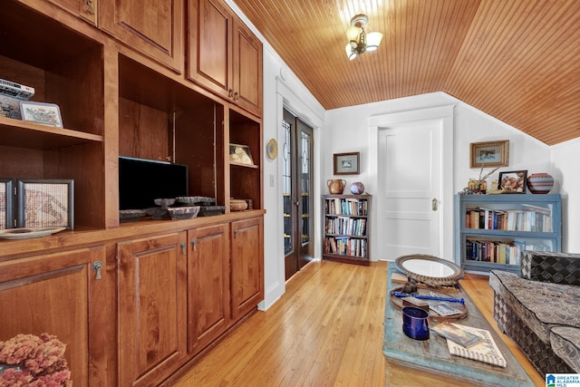 office area with light hardwood / wood-style floors, wooden ceiling, vaulted ceiling, and built in shelves