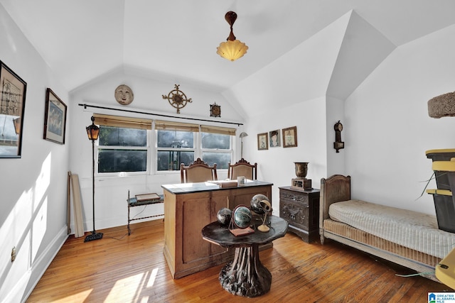 interior space featuring lofted ceiling and light hardwood / wood-style flooring