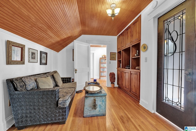 living room with light hardwood / wood-style floors, lofted ceiling, wooden ceiling, and built in features