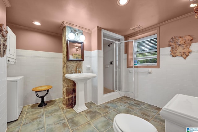 bathroom with a shower with door, tile walls, ornamental molding, and toilet