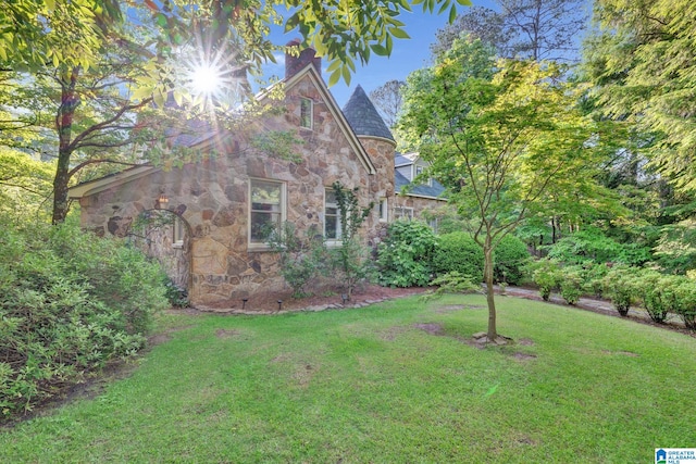 view of side of home featuring a lawn