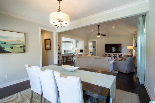 dining area featuring vaulted ceiling, dark hardwood / wood-style floors, and ceiling fan with notable chandelier