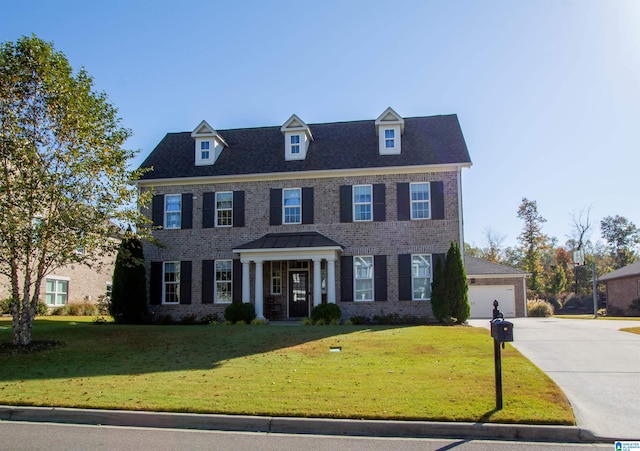 colonial house with a front yard and a garage