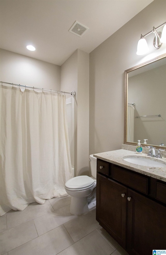 bathroom featuring vanity, toilet, curtained shower, and tile patterned flooring