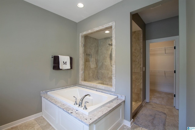 bathroom featuring shower with separate bathtub