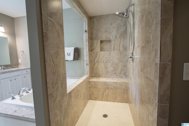 bathroom featuring vanity and independent shower and bath