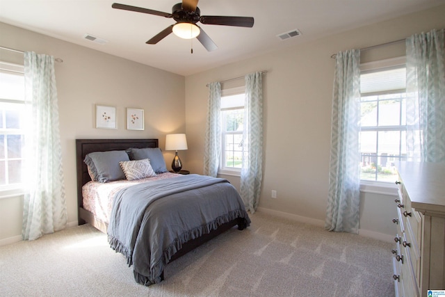 bedroom featuring light carpet and ceiling fan