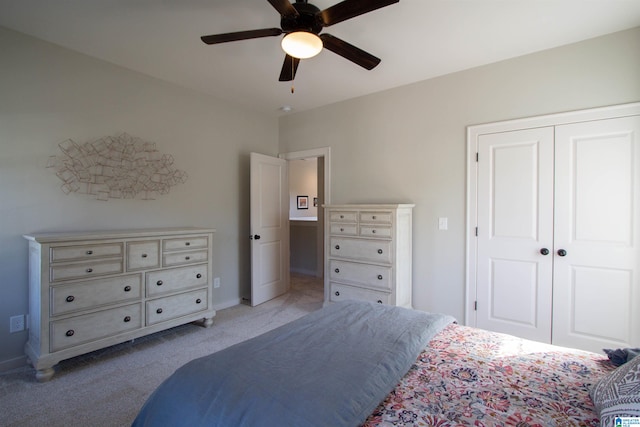 carpeted bedroom featuring a closet and ceiling fan